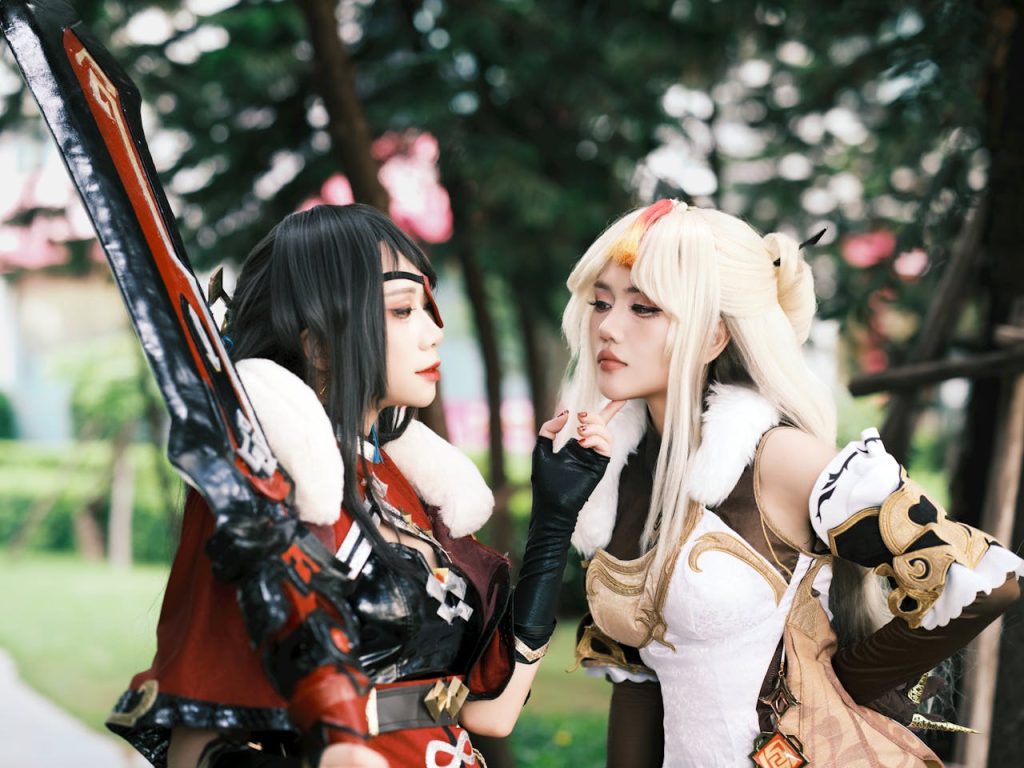 vibrant-cosplay-encounter-in-lush-park-setting-32630090 Two adults in elaborate fantasy cosplay costumes engage outdoors, surrounded by greenery.