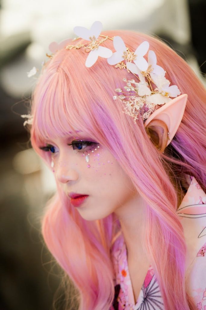 A side view portrait of a young woman in cosplay with floral accessories and vibrant pastel colors.